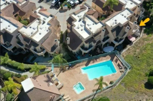 an aerial view of a house with a yard