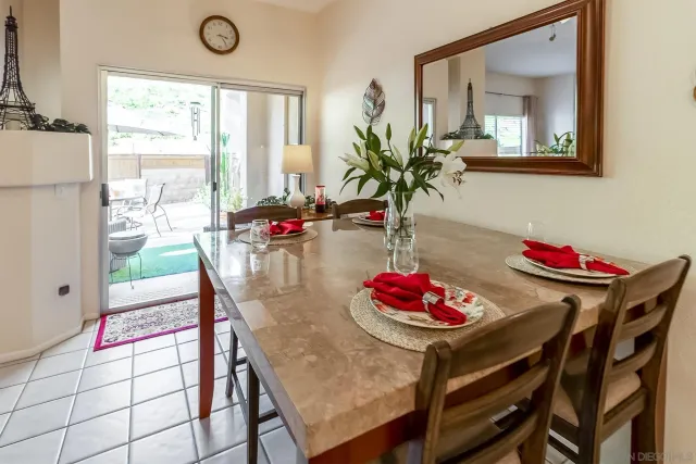 a view of a dining room with furniture and a potted plant