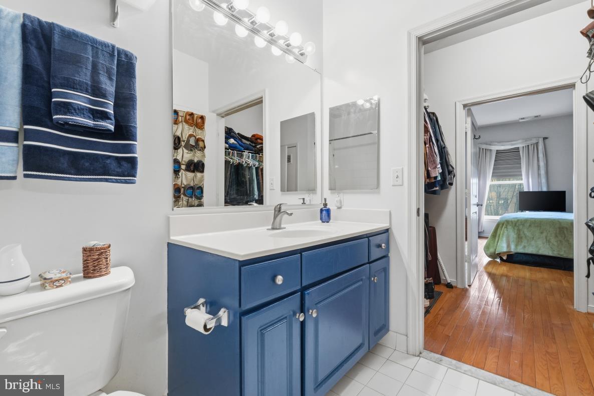 8045 Newell Street, Unit 423 Silver Spring, MD 20910 - Photo 19 of 26 a bathroom with a sink a toilet and shower