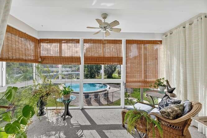 1200 Southwest 12th Court, Unit 203 Fort Lauderdale, FL 33315 - Photo 1 of 23 a living room with patio furniture and a large window