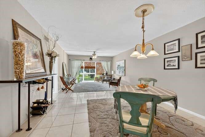 1200 Southwest 12th Court, Unit 203 Fort Lauderdale, FL 33315 - Photo 11 of 23 a living room with furniture a chandelier and a window