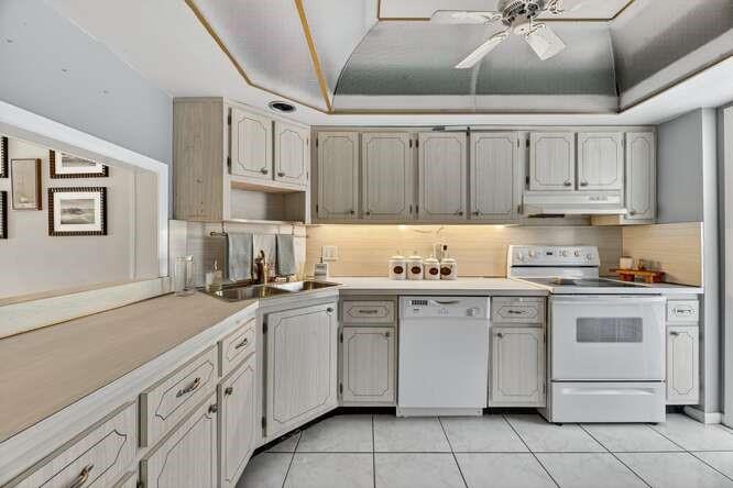 1200 Southwest 12th Court, Unit 203 Fort Lauderdale, FL 33315 - Photo 12 of 23 a kitchen with cabinets appliances a sink and a counter top space