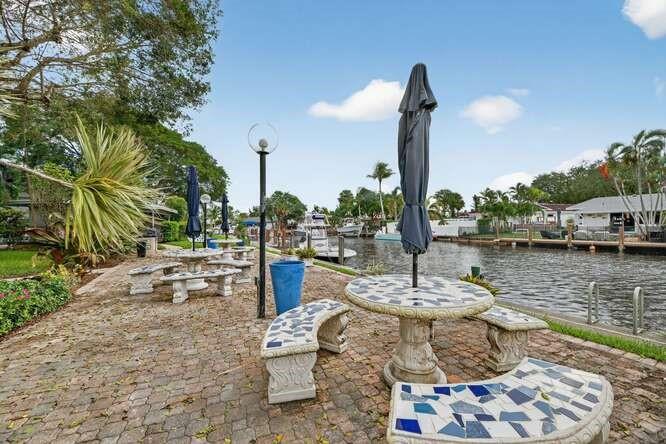 1200 Southwest 12th Court, Unit 203 Fort Lauderdale, FL 33315 - Photo 20 of 23 a view of a lake with couches and wooden fence
