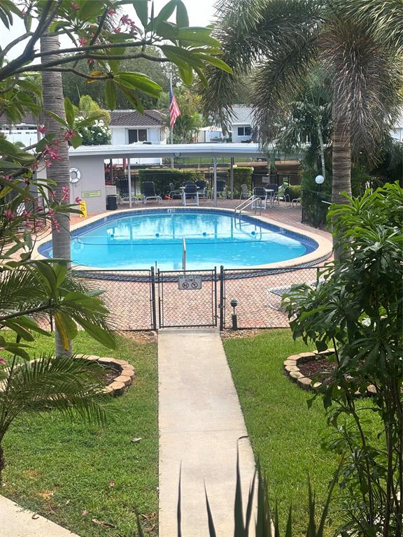 1200 Southwest 12th Court, Unit 203 Fort Lauderdale, FL 33315 - Photo 5 of 23 a view of a swimming pool with a patio and garden