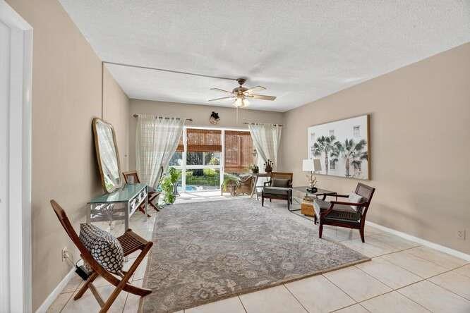 1200 Southwest 12th Court, Unit 203 Fort Lauderdale, FL 33315 - Photo 9 of 23 a living room with furniture a window and a flat screen tv