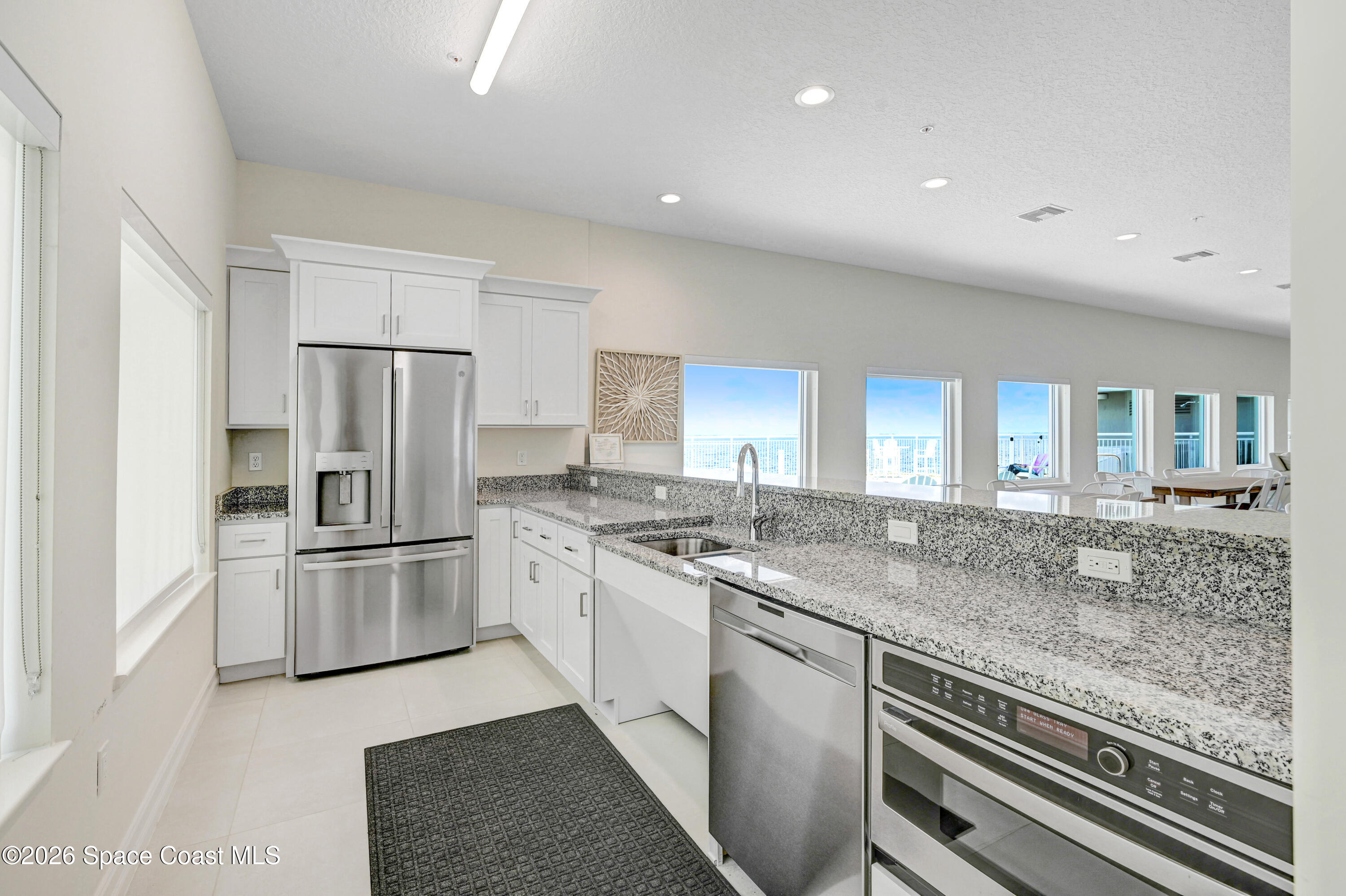 1805 Riverside Drive, Unit 304 Titusville, FL 32780 - Photo 36 of 46 a kitchen with a sink stove and refrigerator