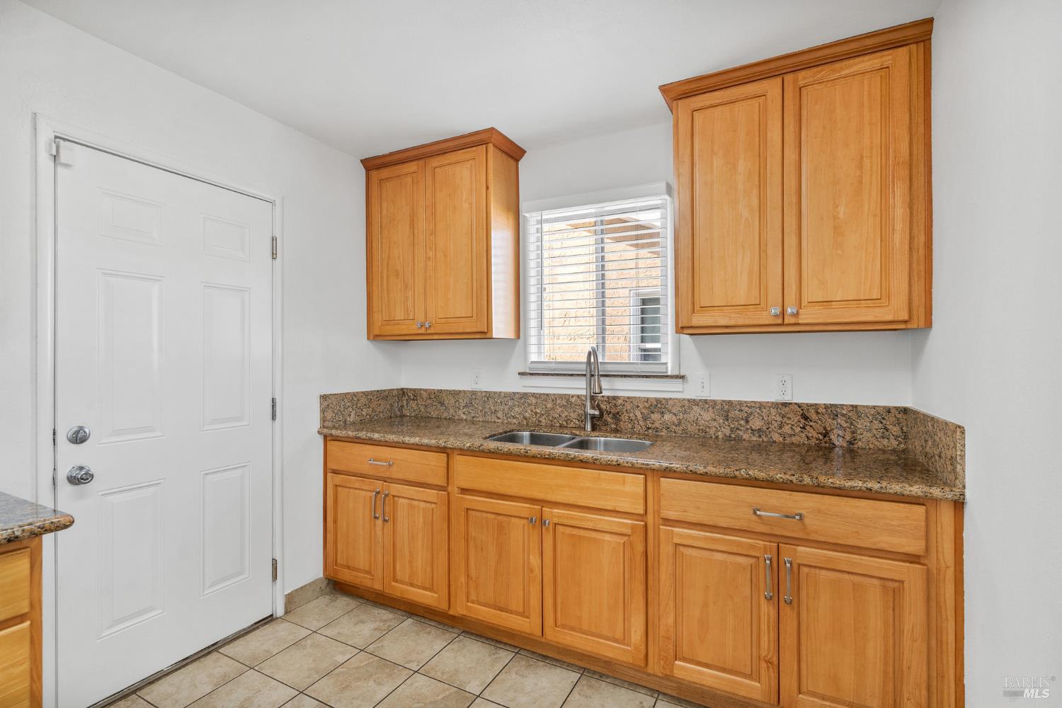 458 Spring Street Richmond, CA 94804 - Photo 12 of 26 a kitchen with granite countertop cabinets sink and window