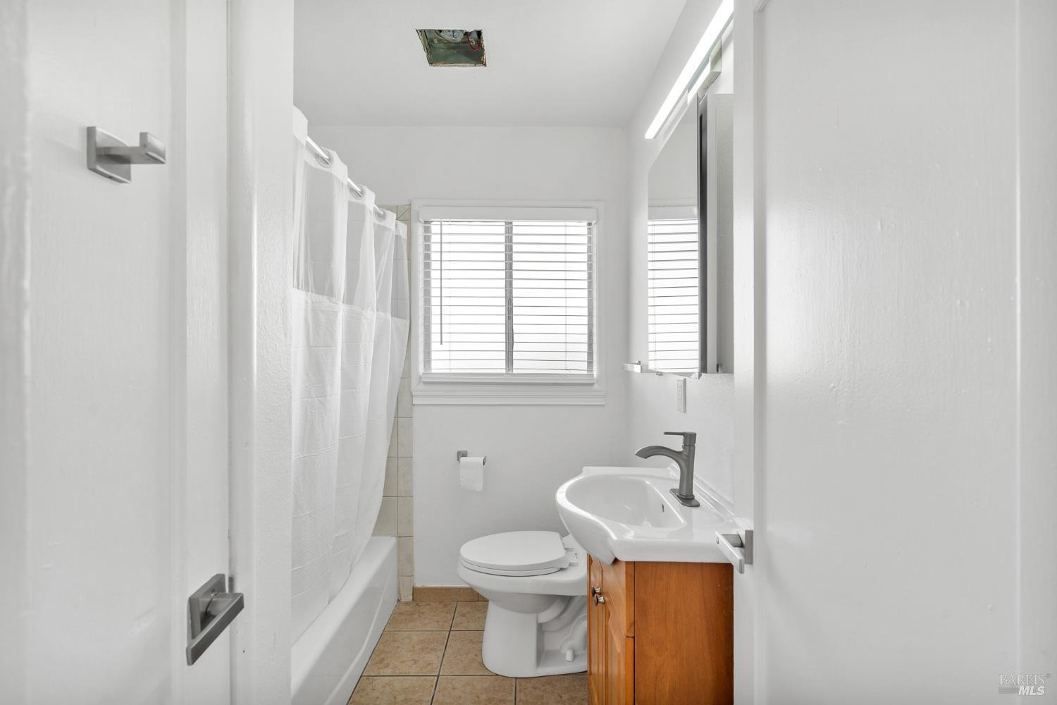 458 Spring Street Richmond, CA 94804 - Photo 13 of 26 a bathroom with a sink a toilet and shower