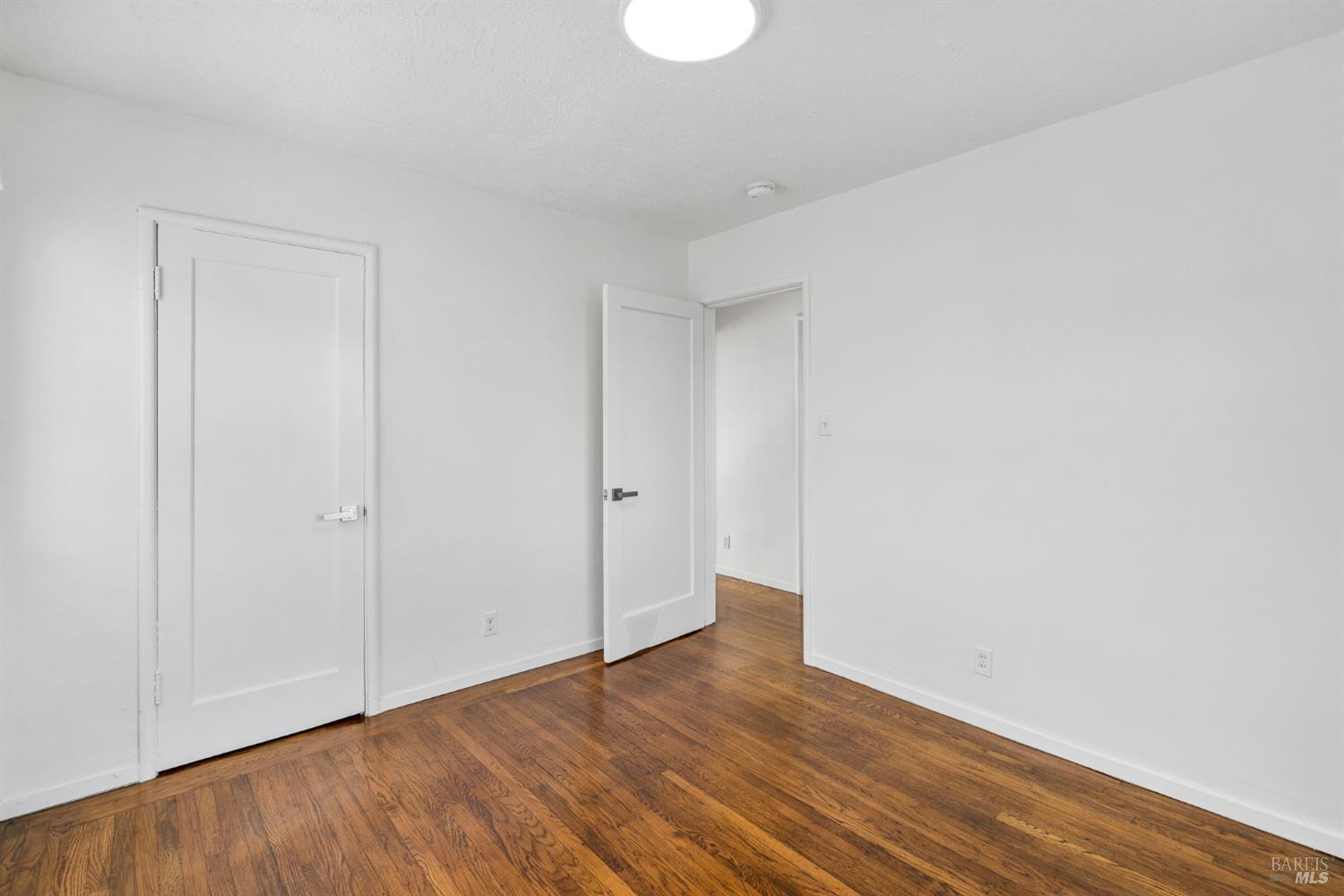 458 Spring Street Richmond, CA 94804 - Photo 16 of 26 a view of an empty room with wooden floor