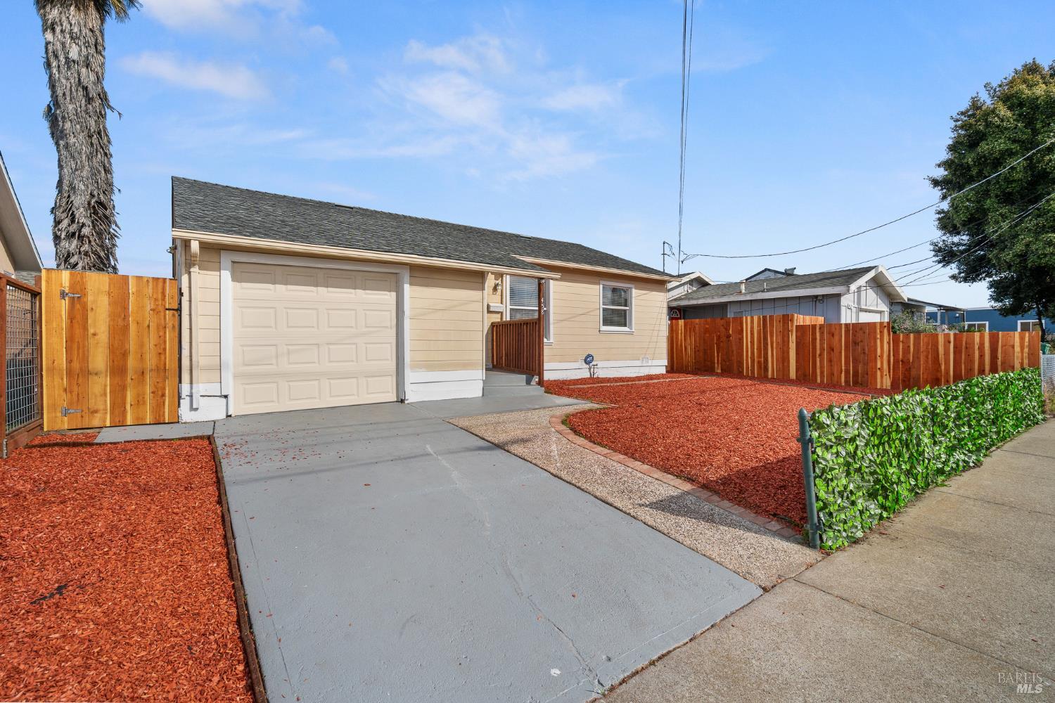 458 Spring Street Richmond, CA 94804 - Photo 2 of 26 a front view of a house with a yard and garage