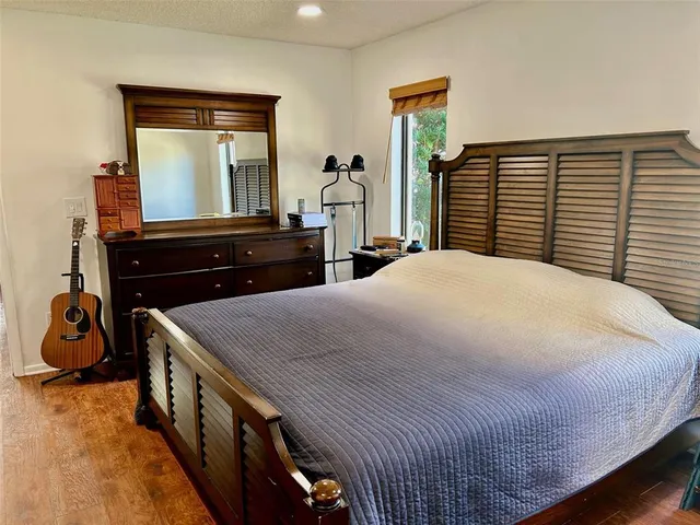 a bedroom with a bed and a dresser