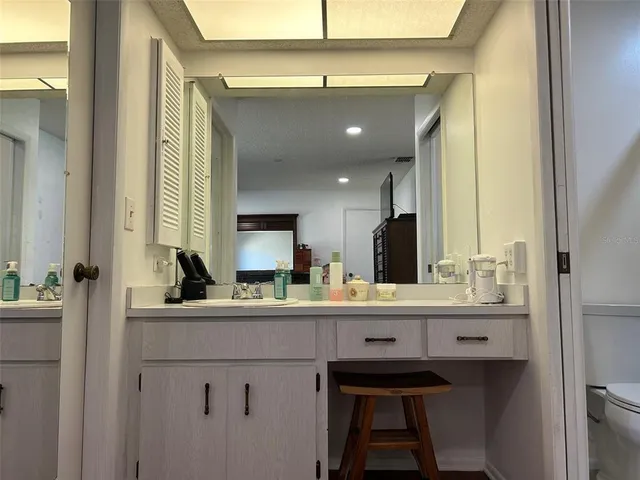 a bathroom with a double vanity sink and a mirror