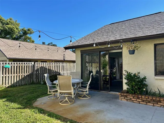 a patio with a table and chairs