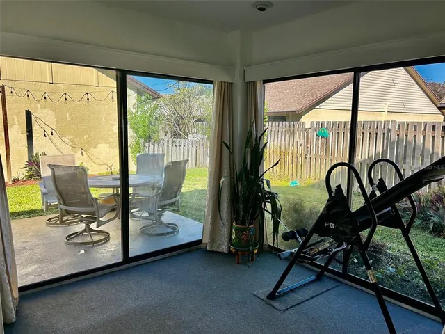 a view of a room with gym equipment and floor to ceiling window