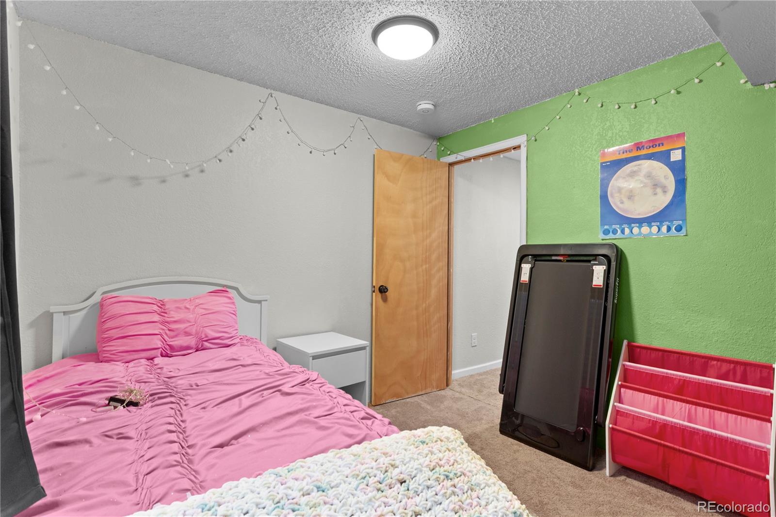 2212 Hyacinth Road Littleton, CO 80129 - Photo 40 of 44 a bedroom with a bed and wooden floor