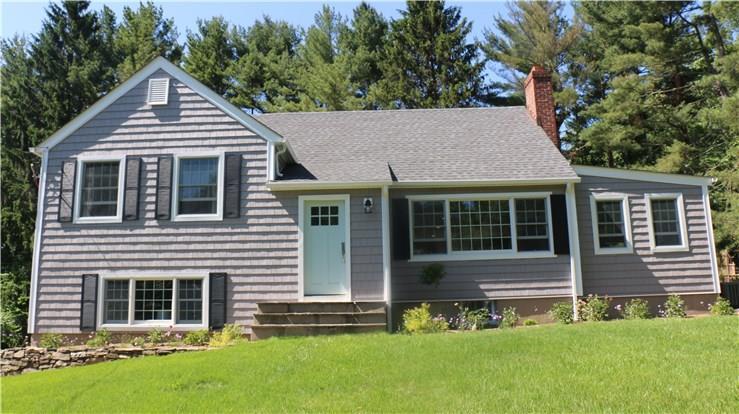 a front view of a house with a yard