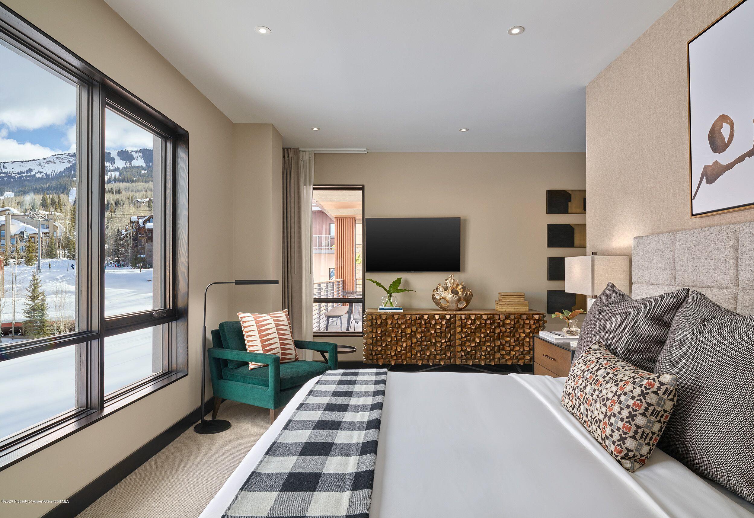 77 Wood Road, Unit 50713 Snowmass Village, CO 81615 - Photo 3 of 6 a bedroom with furniture and a flat screen tv