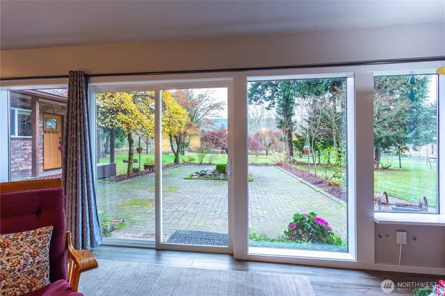 a bedroom with a bed and a large window