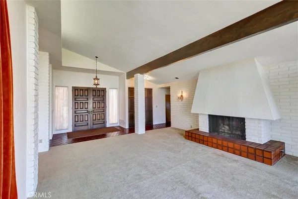 a large hall with a large window and chandelier