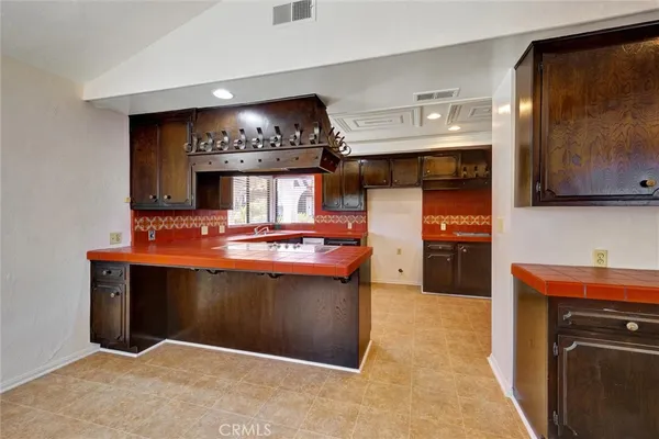 a kitchen with stainless steel appliances granite countertop a refrigerator and a stove