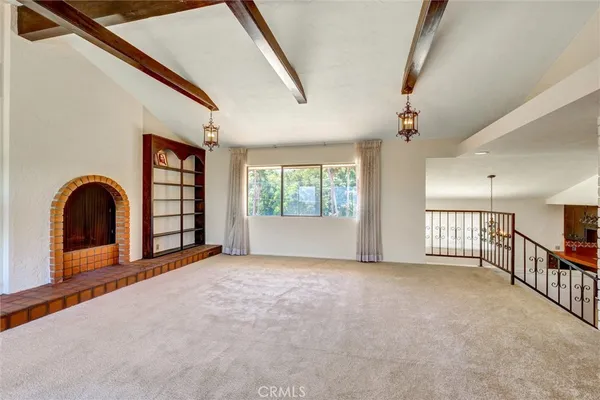 a bedroom with a bed a window and a television
