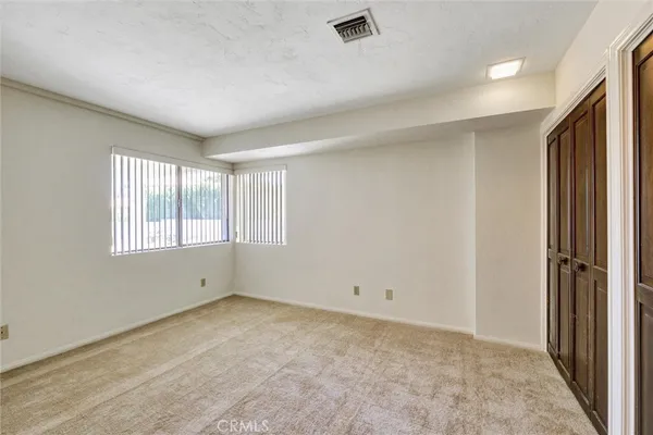 a spacious bathroom with a granite countertop sink a mirror a vanity and shower