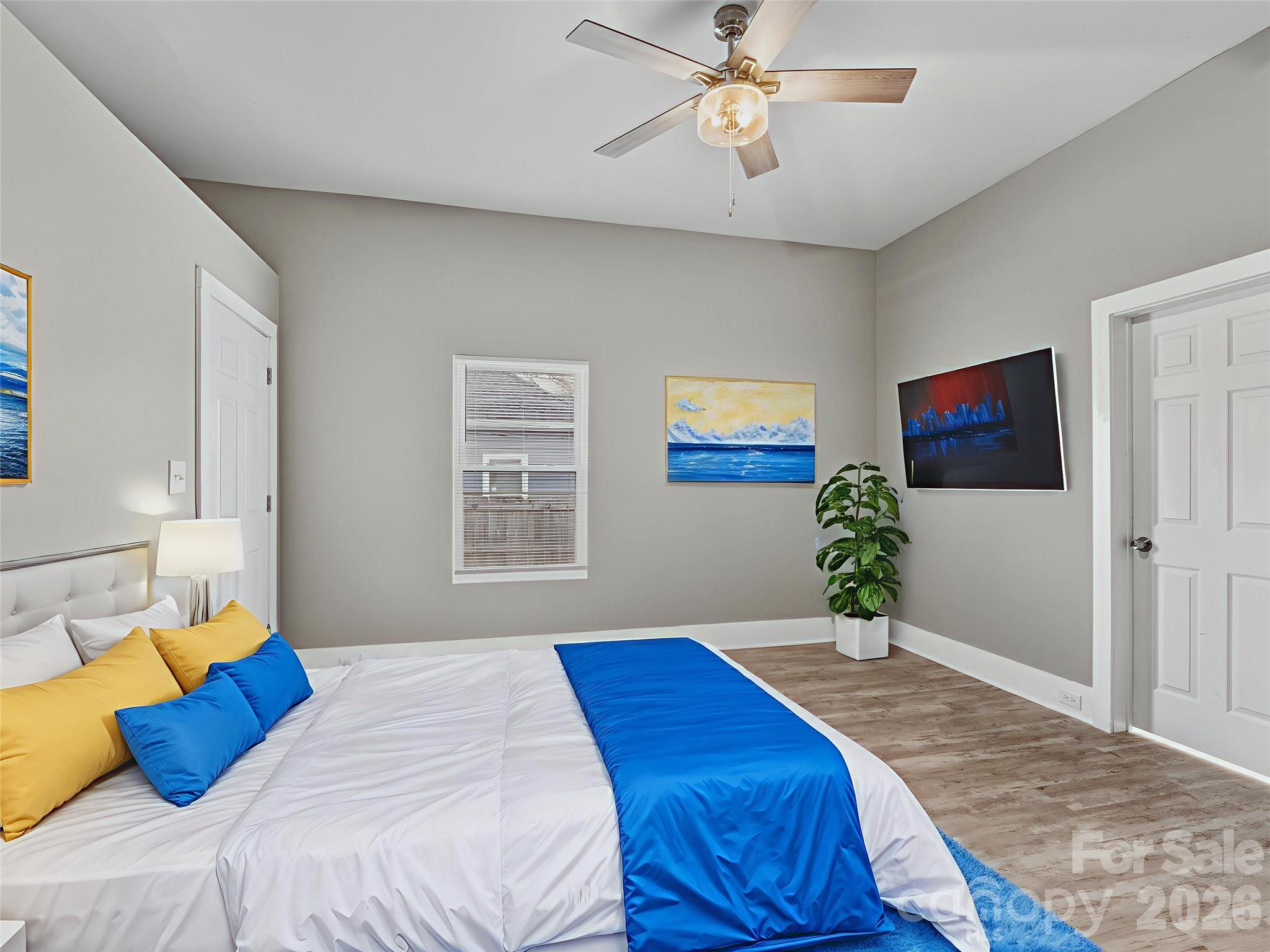 4313 Hovis Road Charlotte, NC 28208 - Photo 12 of 24 a bedroom with a bed and a chandelier