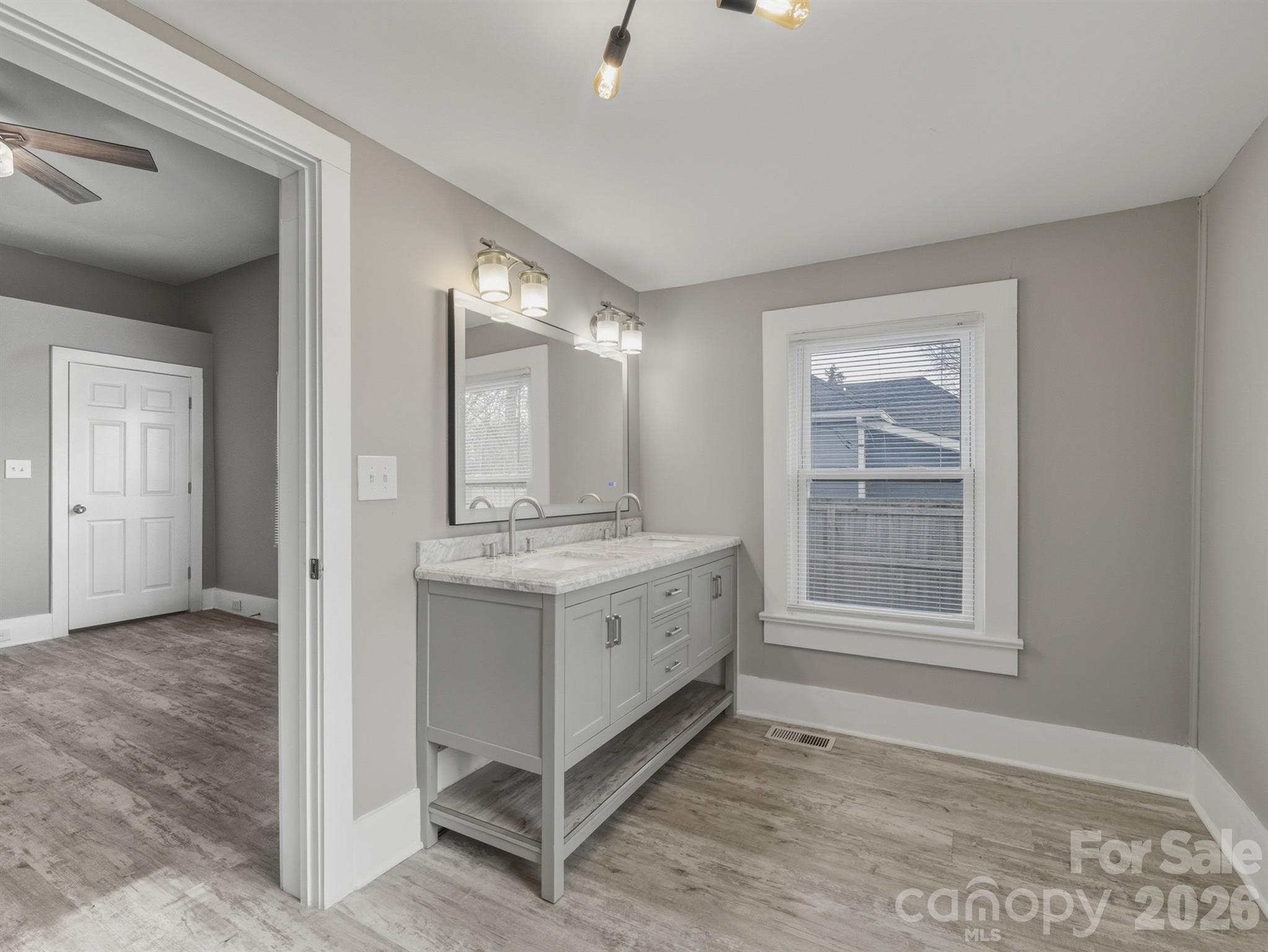 4313 Hovis Road Charlotte, NC 28208 - Photo 14 of 24 a bathroom with a granite countertop sink mirror and vanity