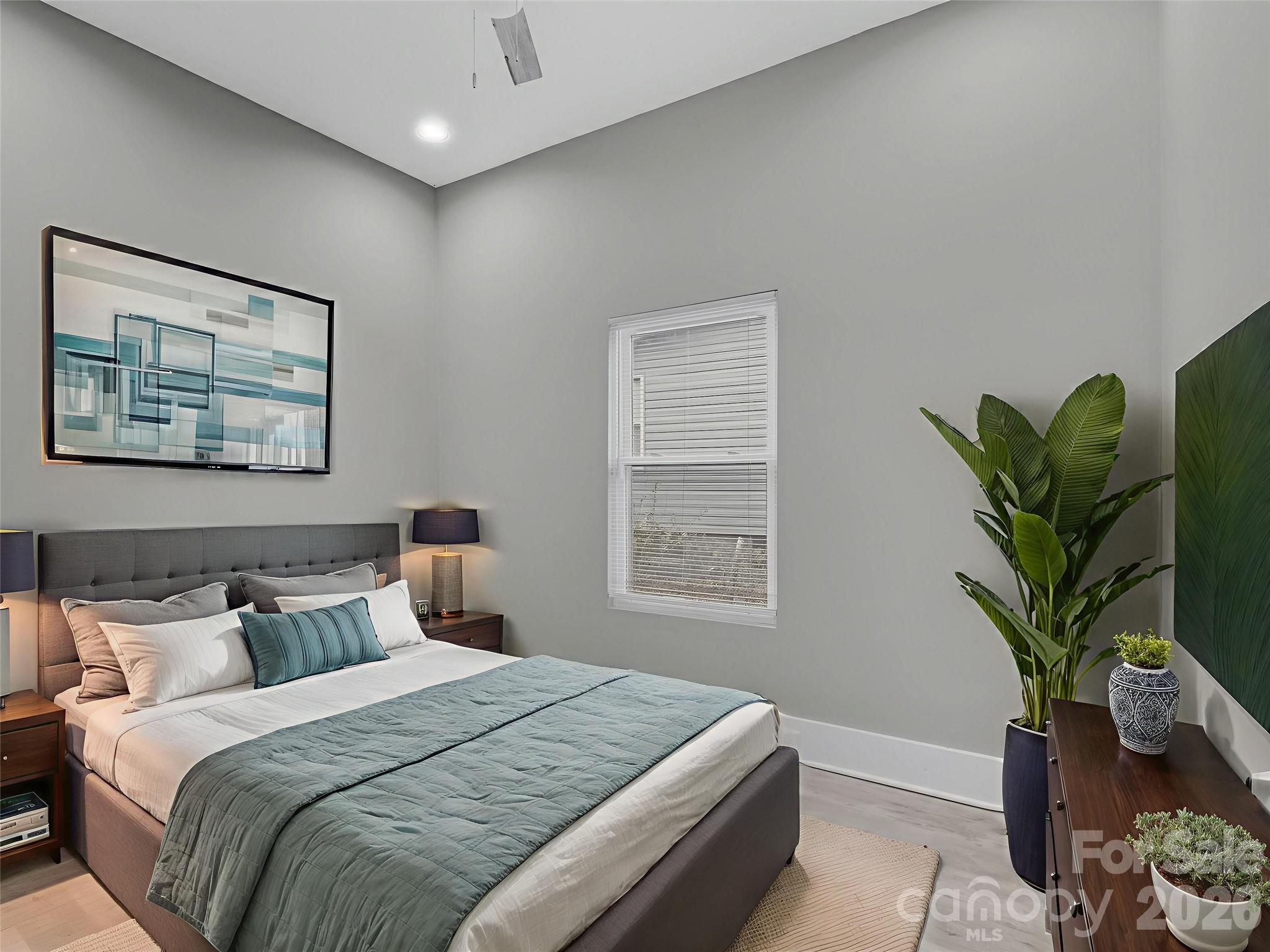 4313 Hovis Road Charlotte, NC 28208 - Photo 16 of 24 a bedroom with bed and a potted plant