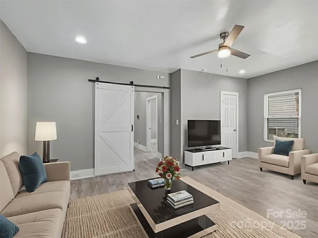 a living room with furniture and a flat screen tv