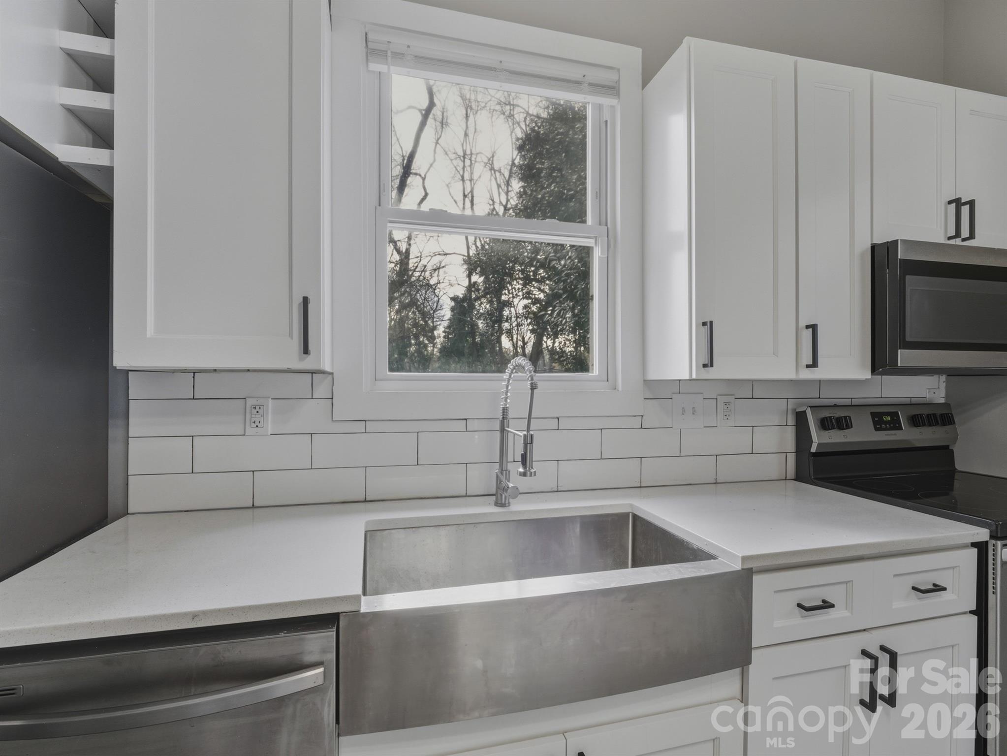 4313 Hovis Road Charlotte, NC 28208 - Photo 5 of 24 a kitchen with a sink and large window