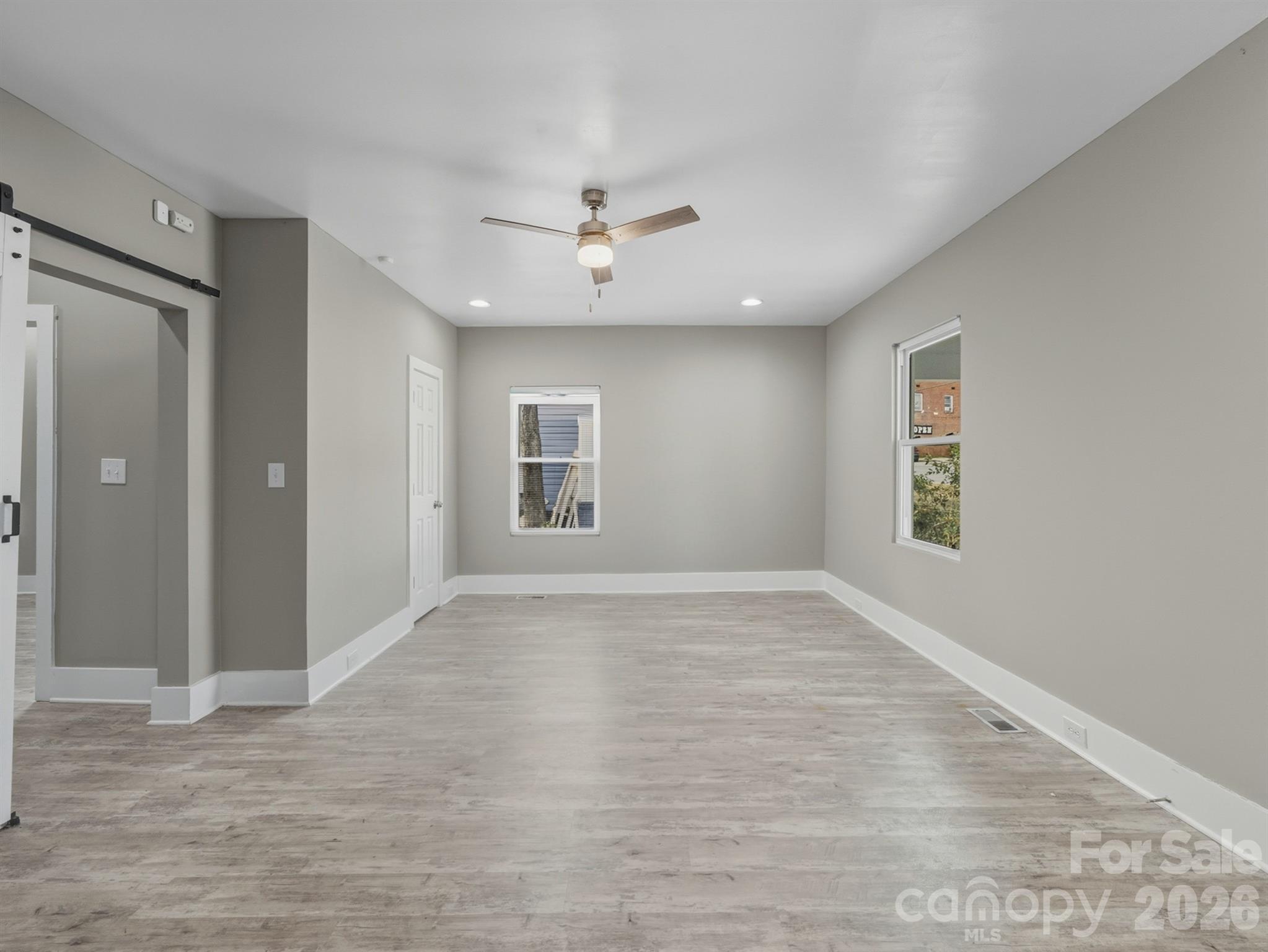 4313 Hovis Road Charlotte, NC 28208 - Photo 8 of 24 wooden floor in an empty room with a window
