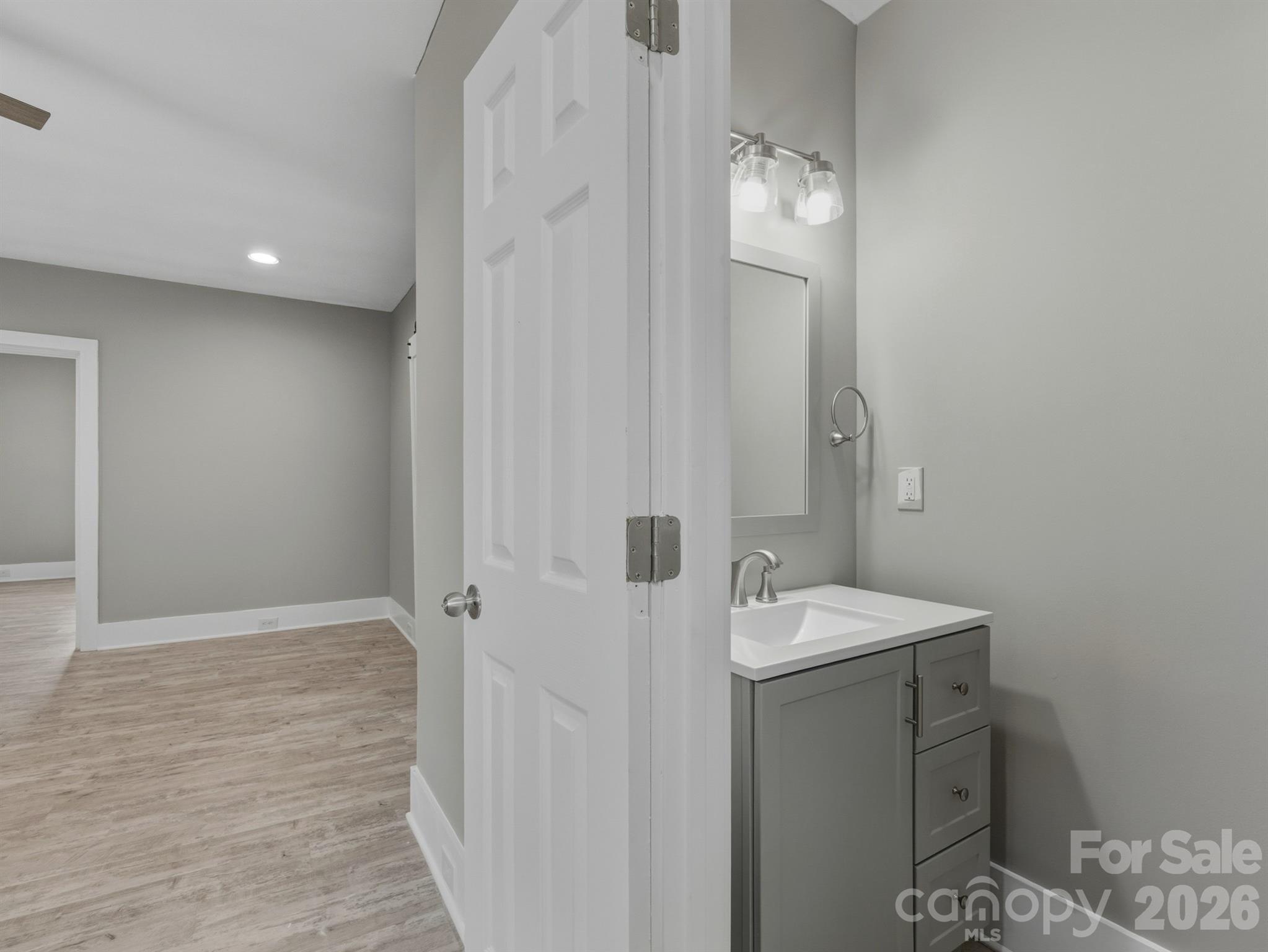 4313 Hovis Road Charlotte, NC 28208 - Photo 9 of 24 a bathroom with a sink a mirror and a shower