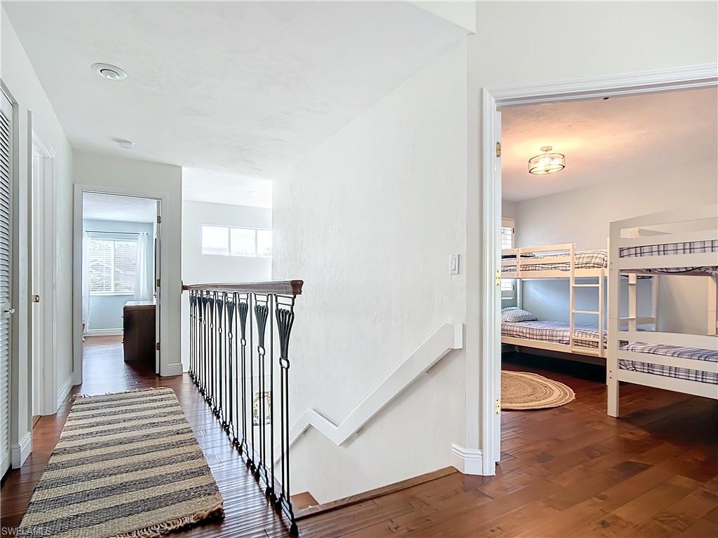 2860 Citrus Lake Drive, Unit R202 Naples, FL 34109 - Photo 22 of 50 a view of a bedroom with wooden floor and windows