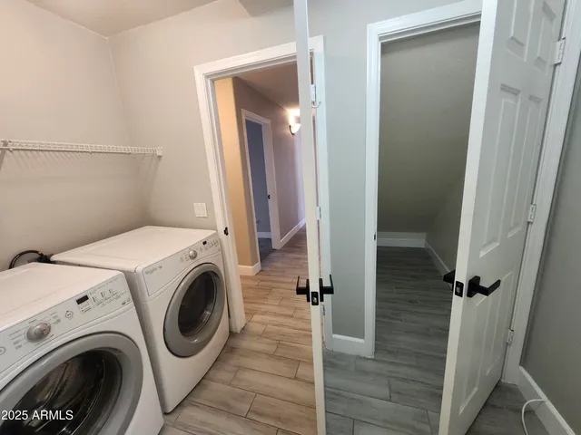 a view of a hallway with washer and dryer