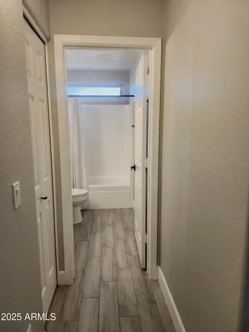 a view of a room with wooden floor