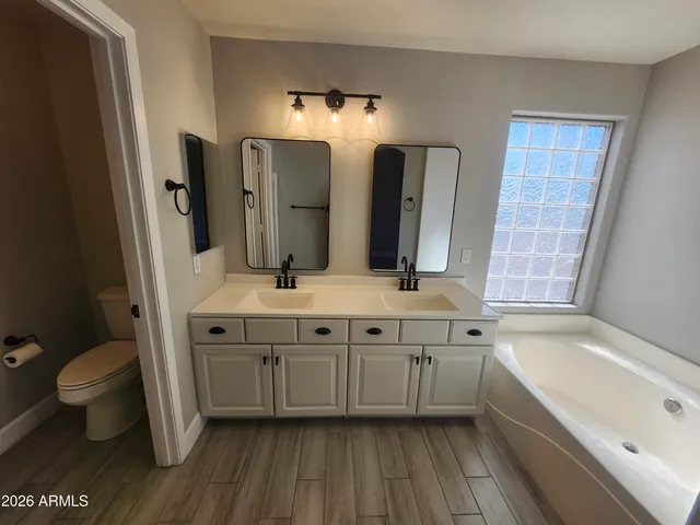 an empty room with closet and mirror