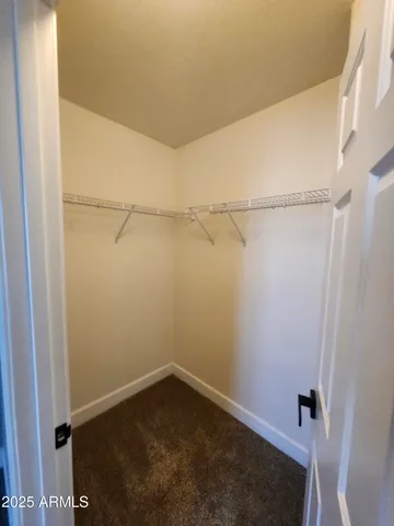 an empty room with a ceiling fan and a window