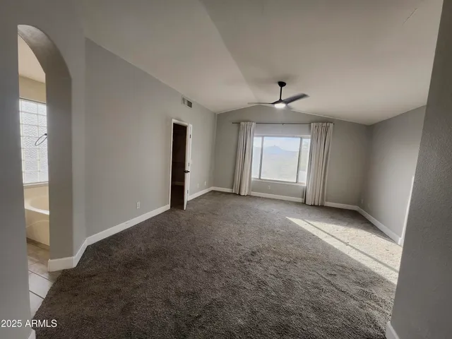 a view of a livingroom with a ceiling fan and window