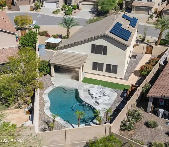 an aerial view of a house with backyard