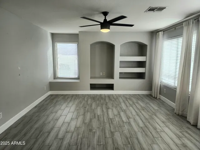 wooden floor in an empty room with a window