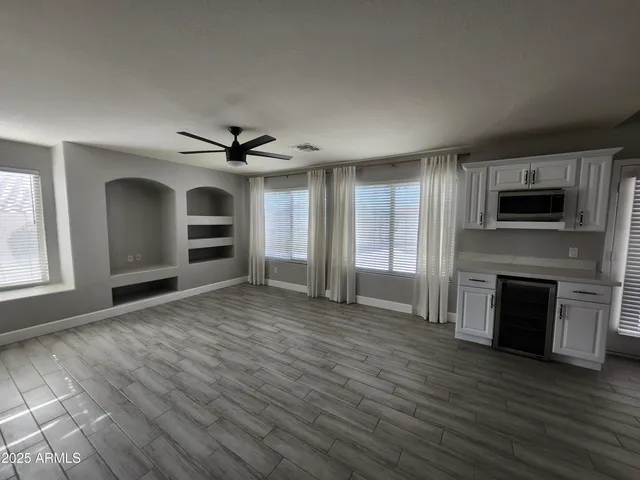 a view of a livingroom with a fireplace wooden floor and window