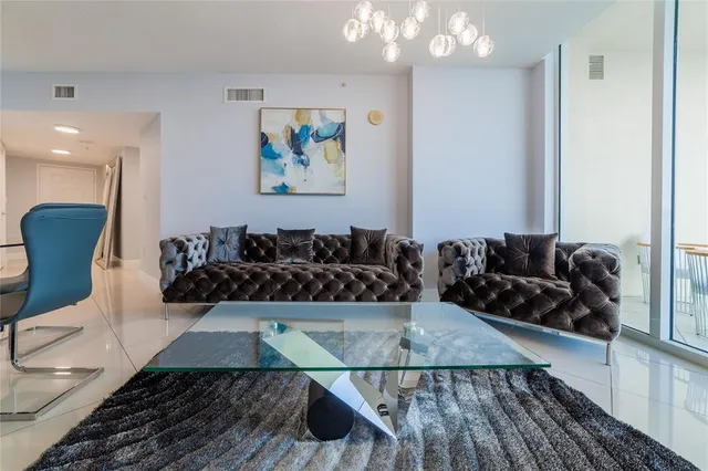 a dining room with furniture and a window