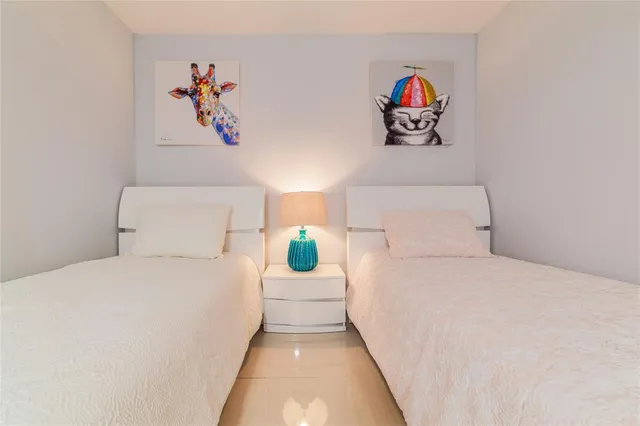 a large bed sitting in a bedroom next to a window