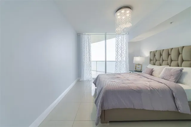 a bedroom with a bed and painting on the wall