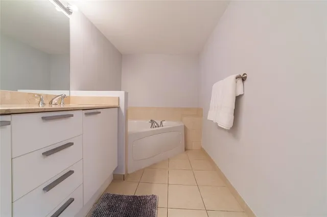 a bathroom with a granite countertop sink mirror and double