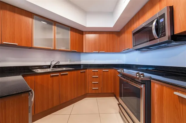 a kitchen with stainless steel appliances granite countertop a sink and cabinets