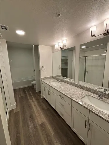 a bathroom with double vanity sink and a mirror