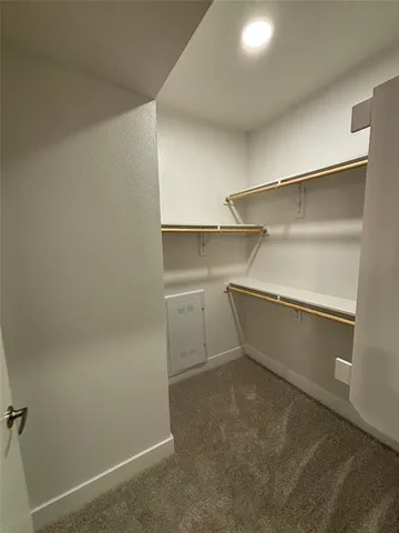 a view of a room with shelf on the wall