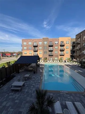 a view of a swimming pool with an outdoor seating